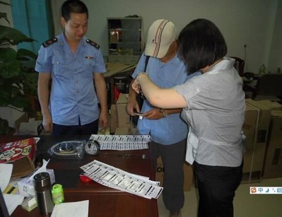 潮州地區(qū)工商局執(zhí)法人員與科勒工作人員正在取證偽造科勒產品標簽